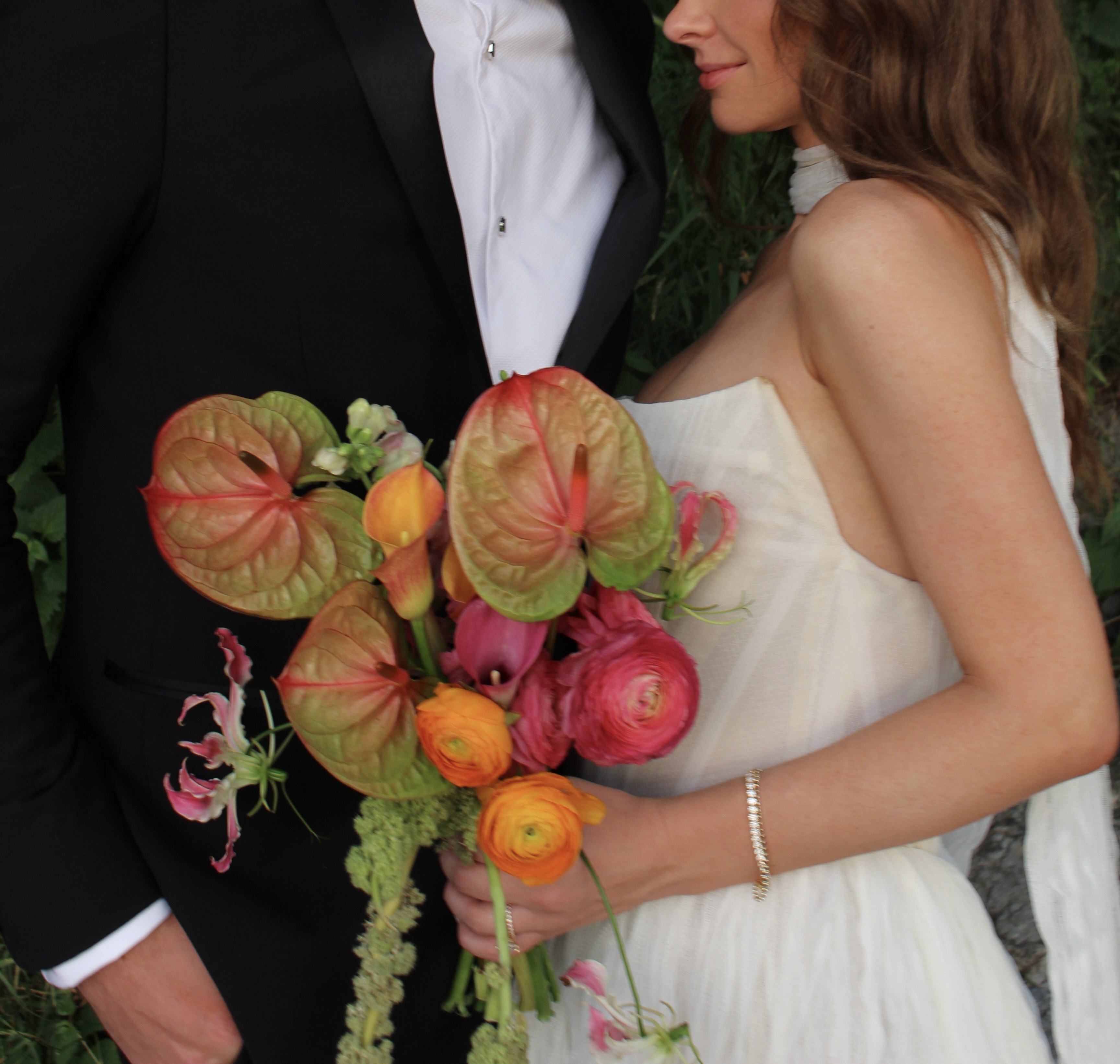 Bridal bouquet with anthurium, ranunculus, calla lily, and gloriosa by Wilted NYC