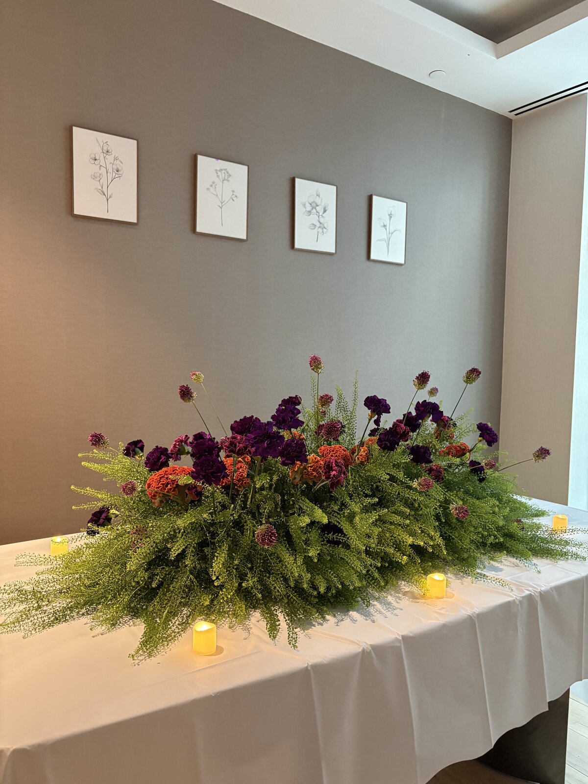 Low garden-style centerpiece with scabiosa and amaranthus by Wilted NYC