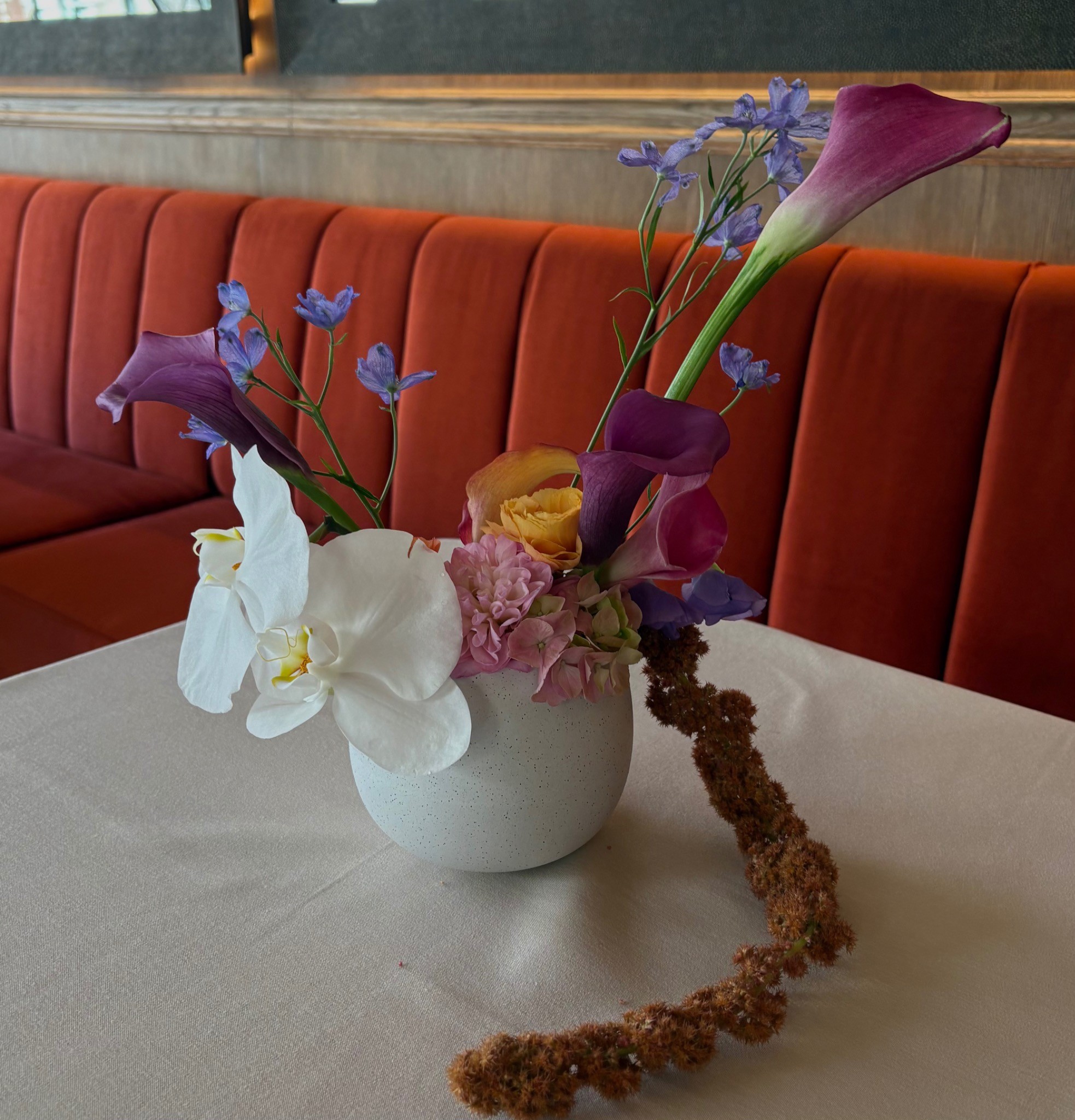 Restaurant floral placement with calla lilies and orchids by Wilted NYC