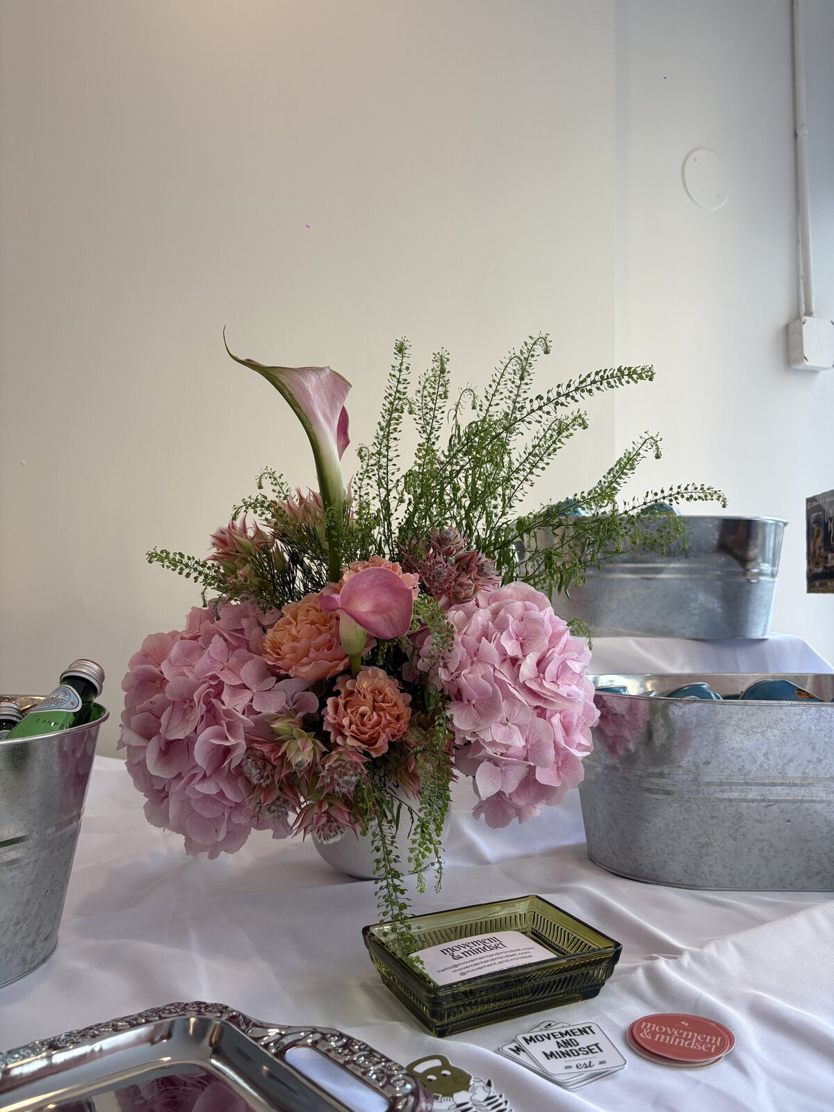 Pink hydrangea, ranunculus, and calla lily arrangement by Wilted NYC