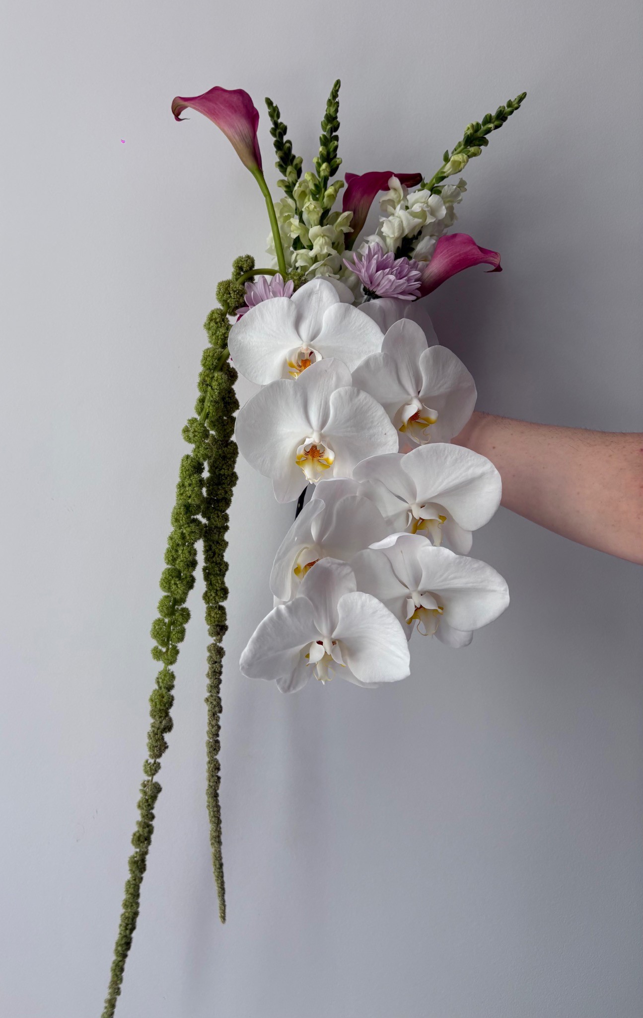 White orchid bridal bouquet with sculptural green amaranthus by Wilted NYC