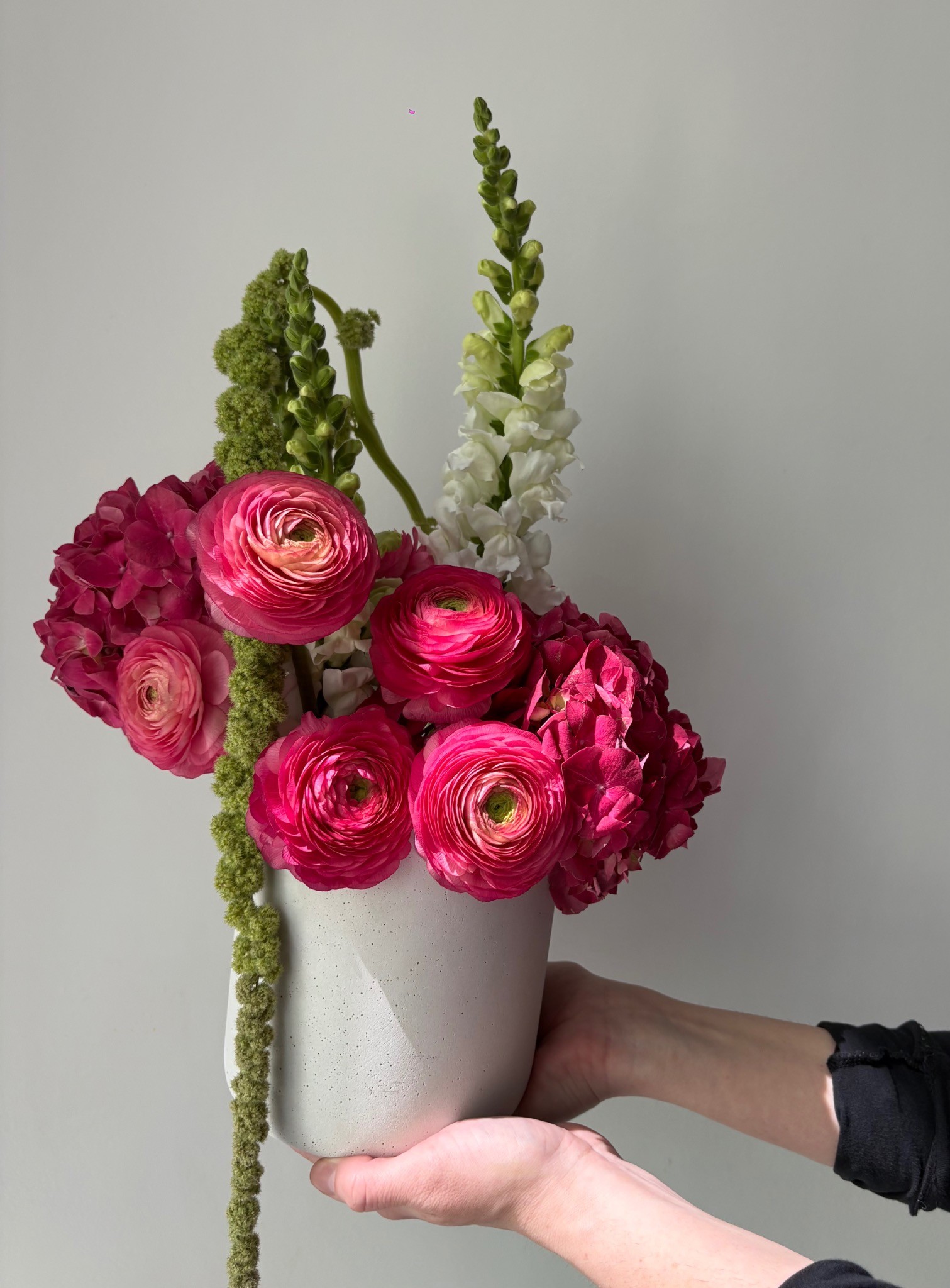 Pink ranunculus and hydrangea sculptural floral arrangement by Wilted NYC