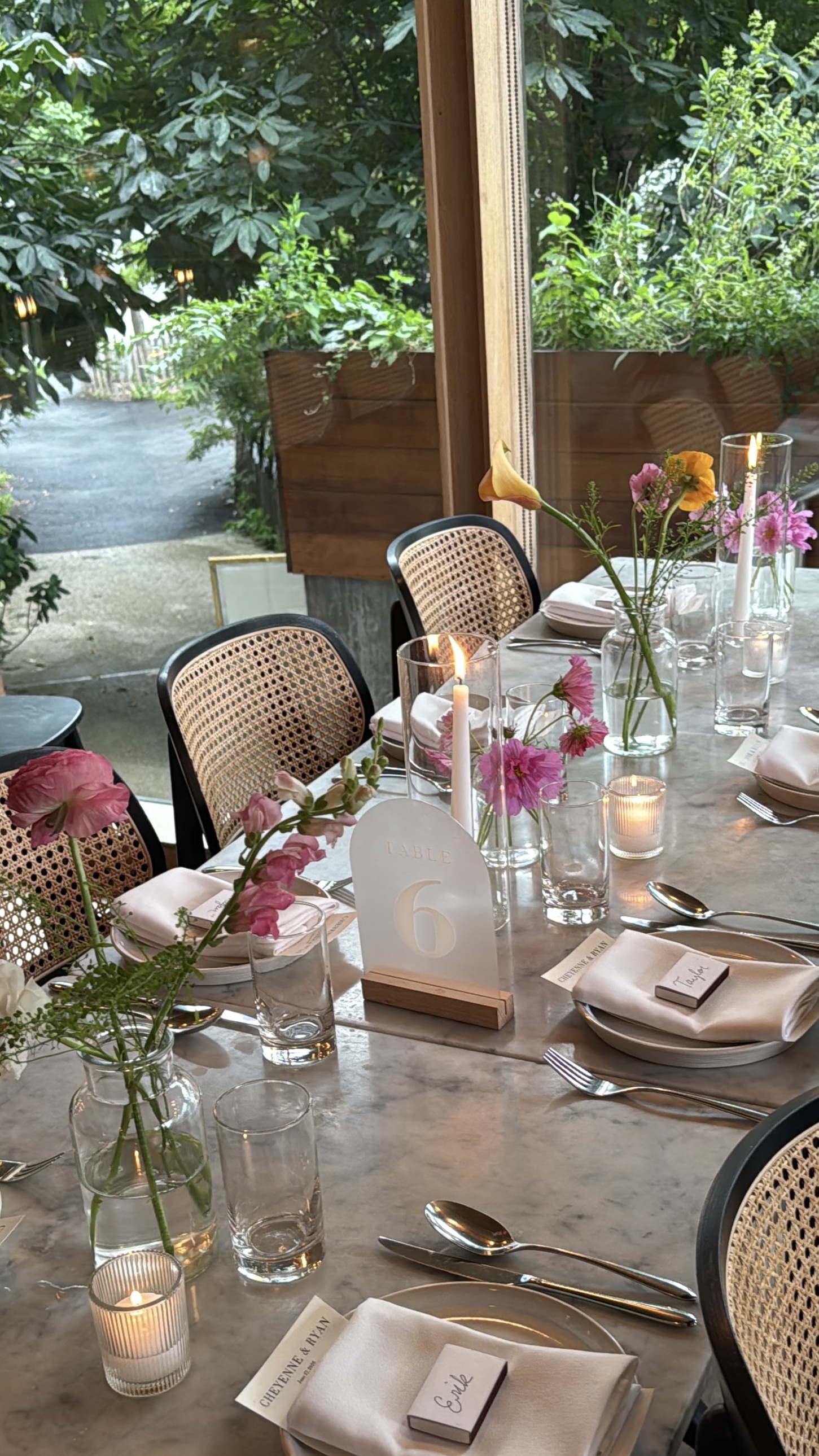 Wedding reception tablescape with bud vases, ranunculus, and cosmos by Wilted NYC